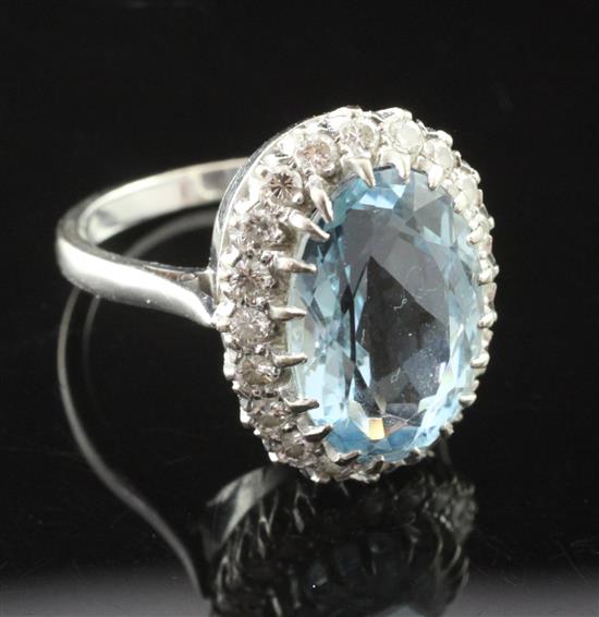 A modern 18ct white gold, aquamarine and diamond cluster ring, size Q.